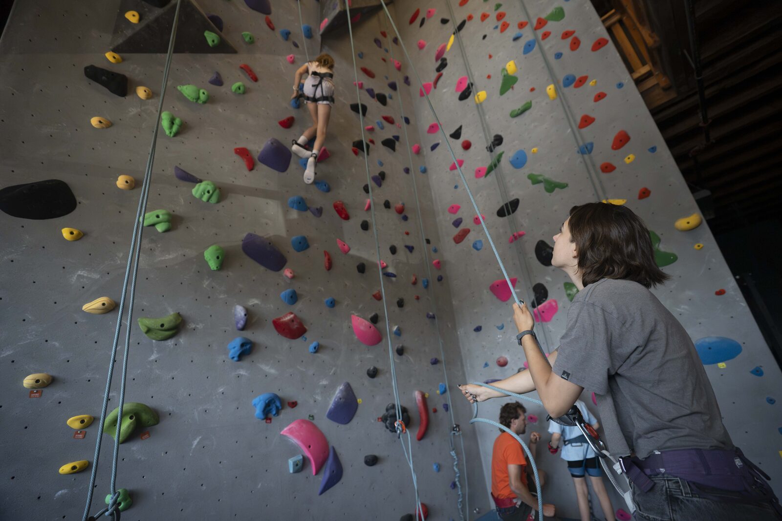 Climber and belayer on the roped wall